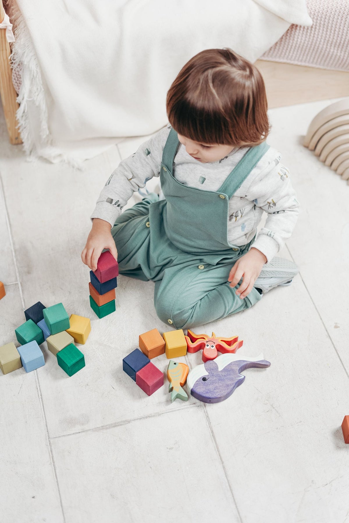 Young child playing with toys on the floor